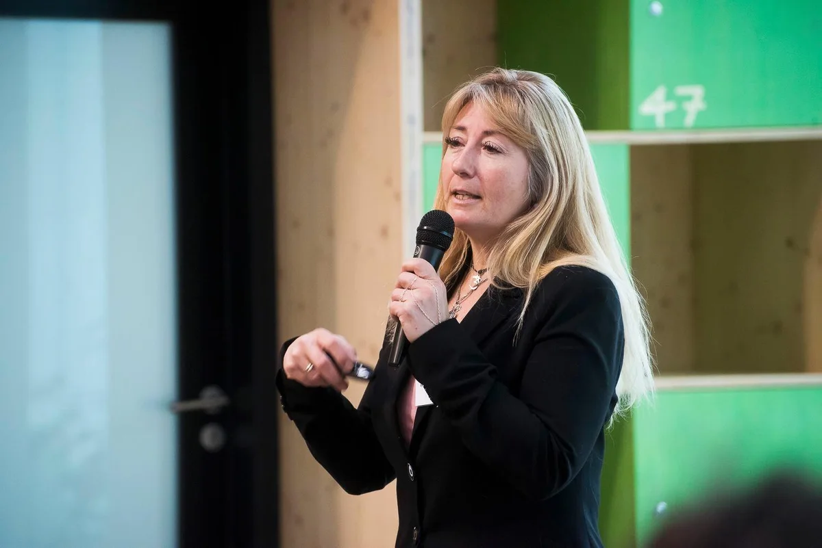 Rachel Paling delivering a talk with a microphone
