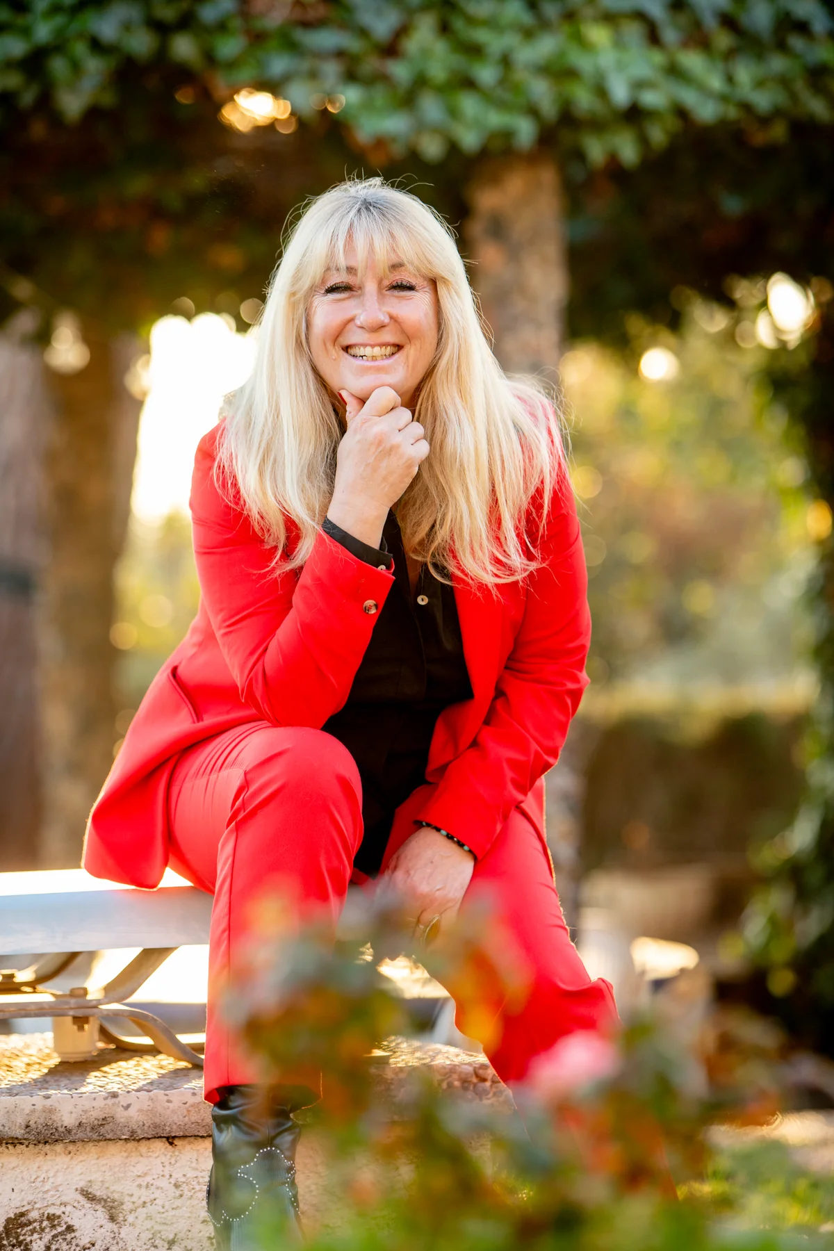 Rachel sitting outdoors in a red jacket
